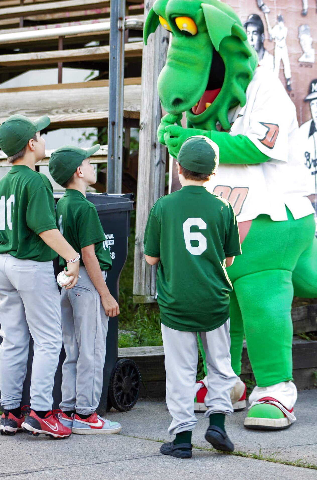 Cooper the Dragon greeting a youth team along the concourse.